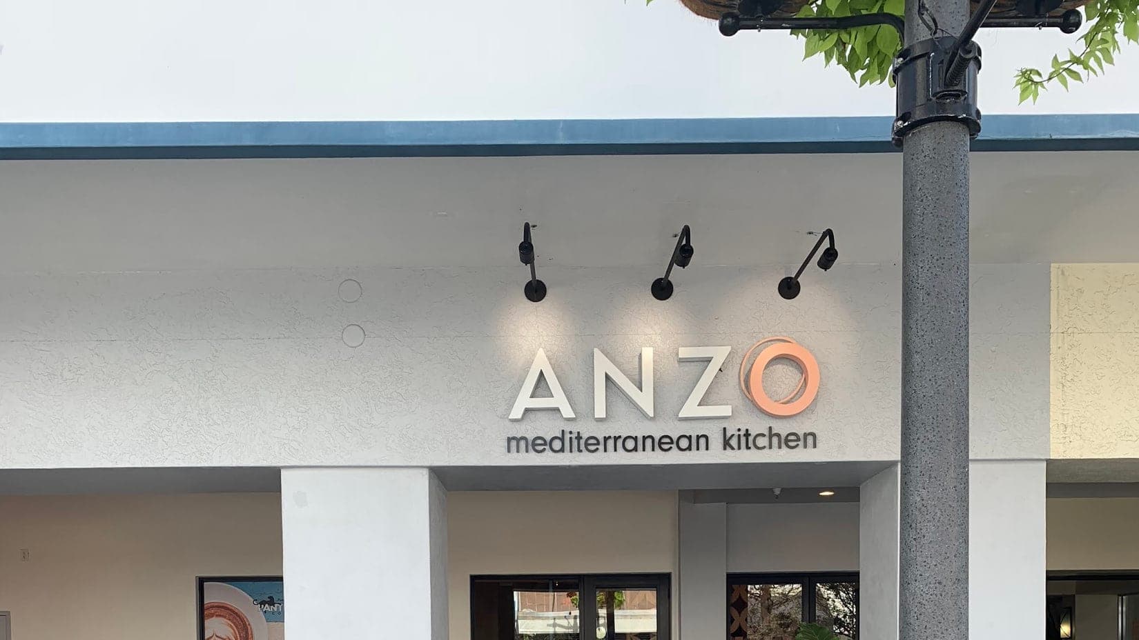 Dimensional letters with a backlit ring over a Mediterranean kitchen in Palm Beach Gardens