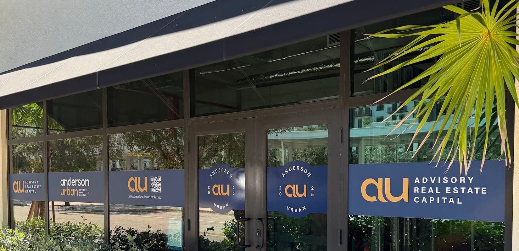 Navy window bands carrying one logo system across an office storefront