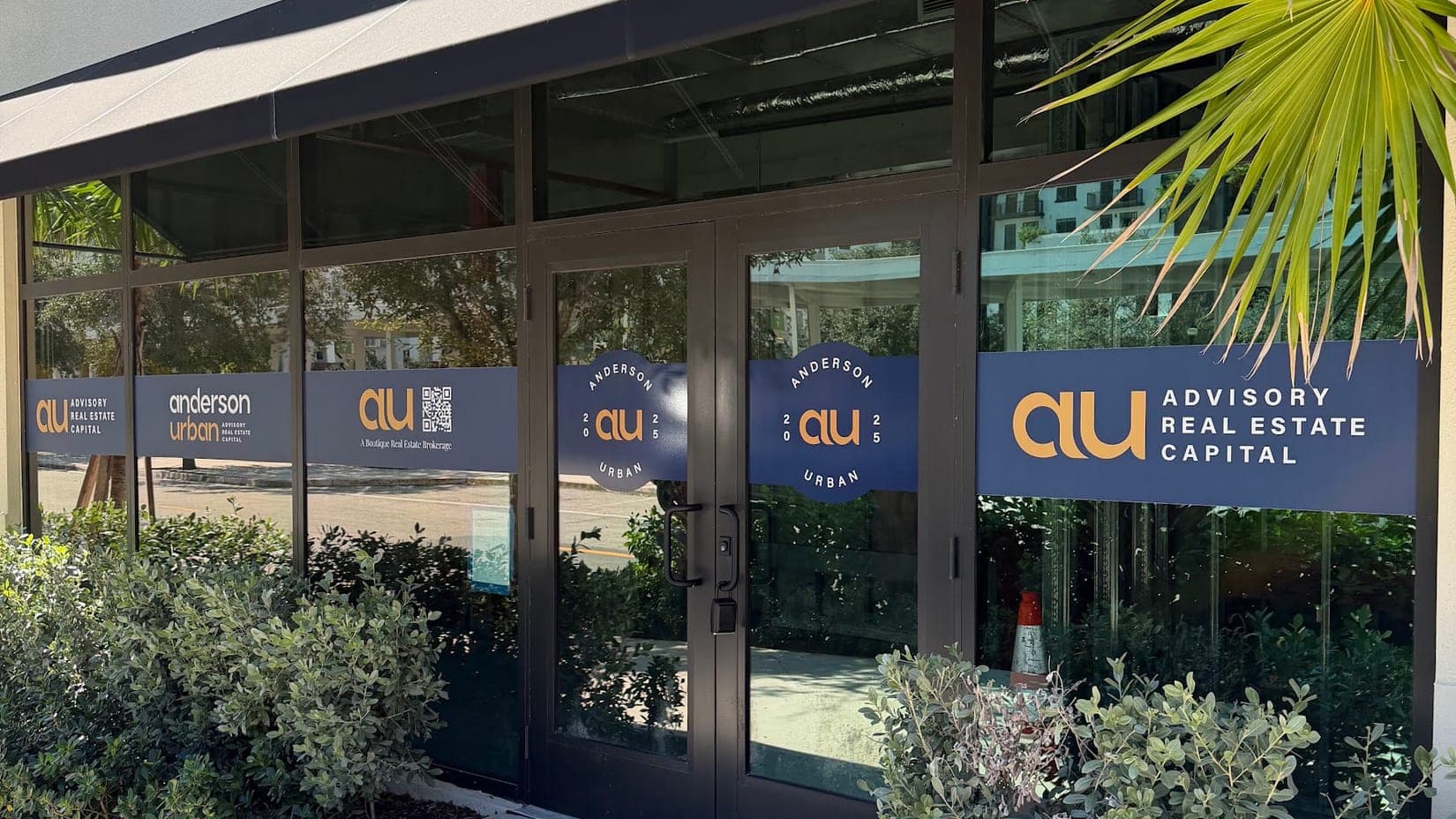 Branded window vinyl across the storefront of a real estate capital firm