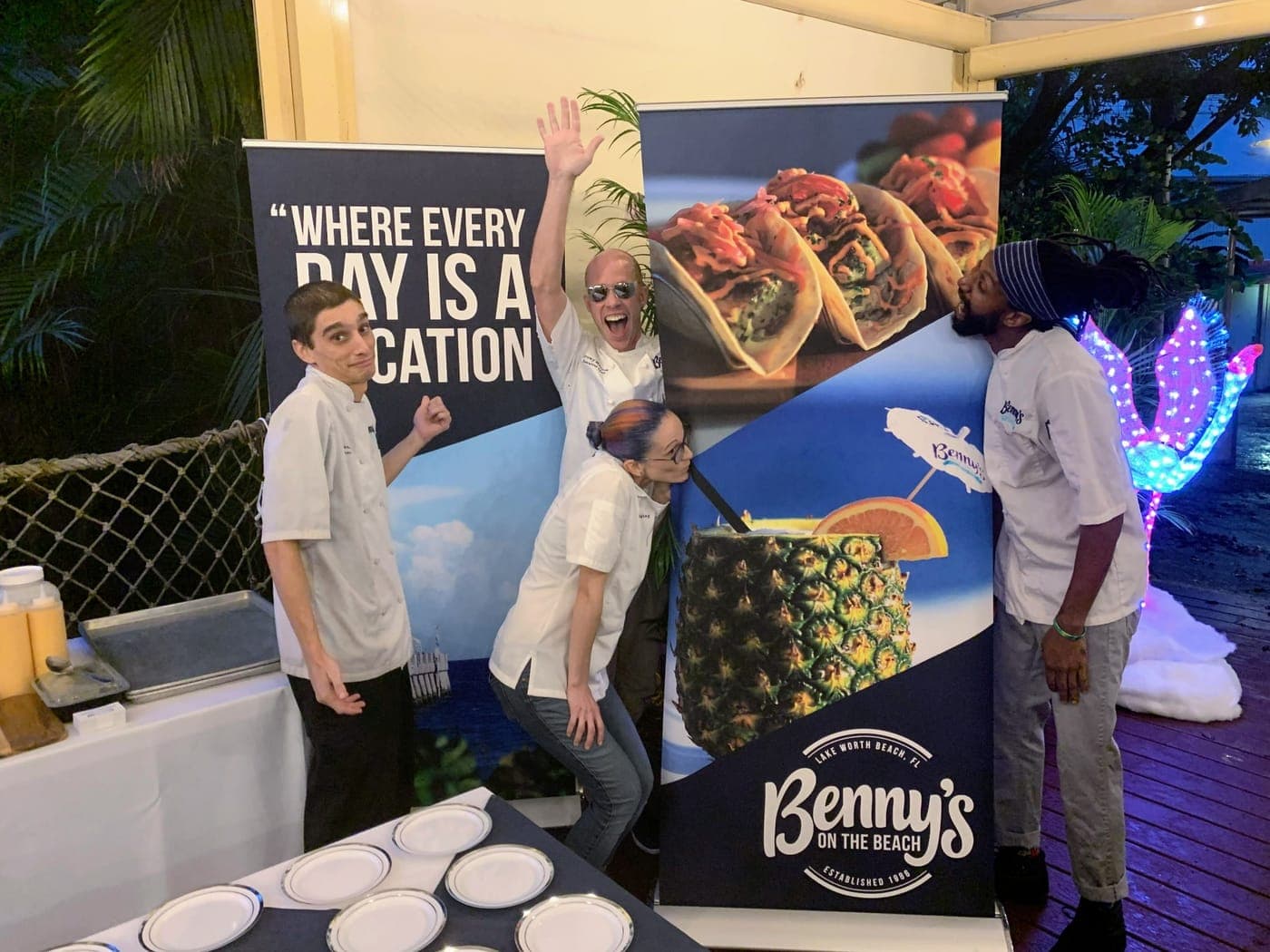 A printed banner display at a beachfront restaurant event