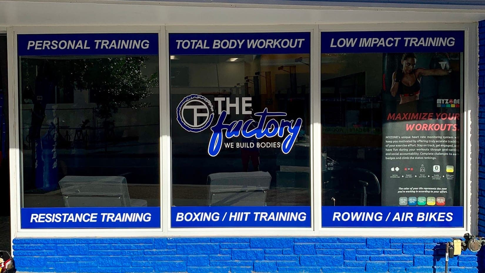 Blue window graphics running the length of a fitness studio