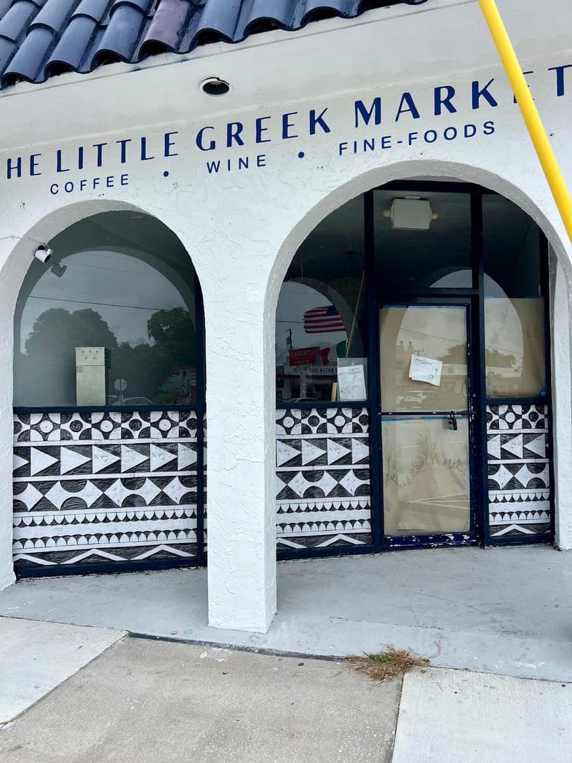 Arched storefront lettering and pattern graphics on a Greek market