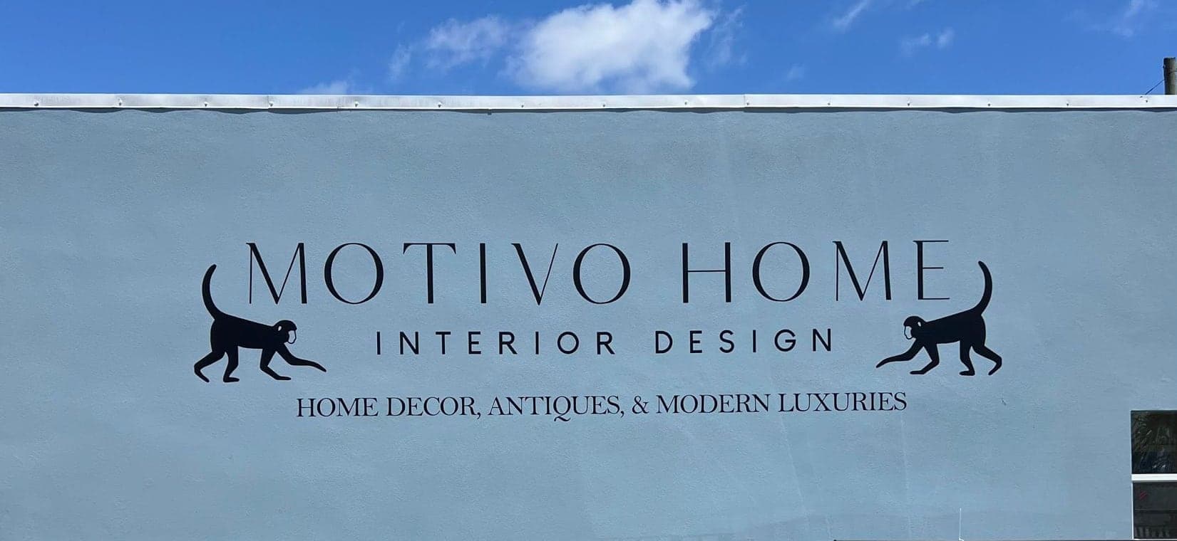 Painted lettering and a monkey crest on an interior design showroom wall