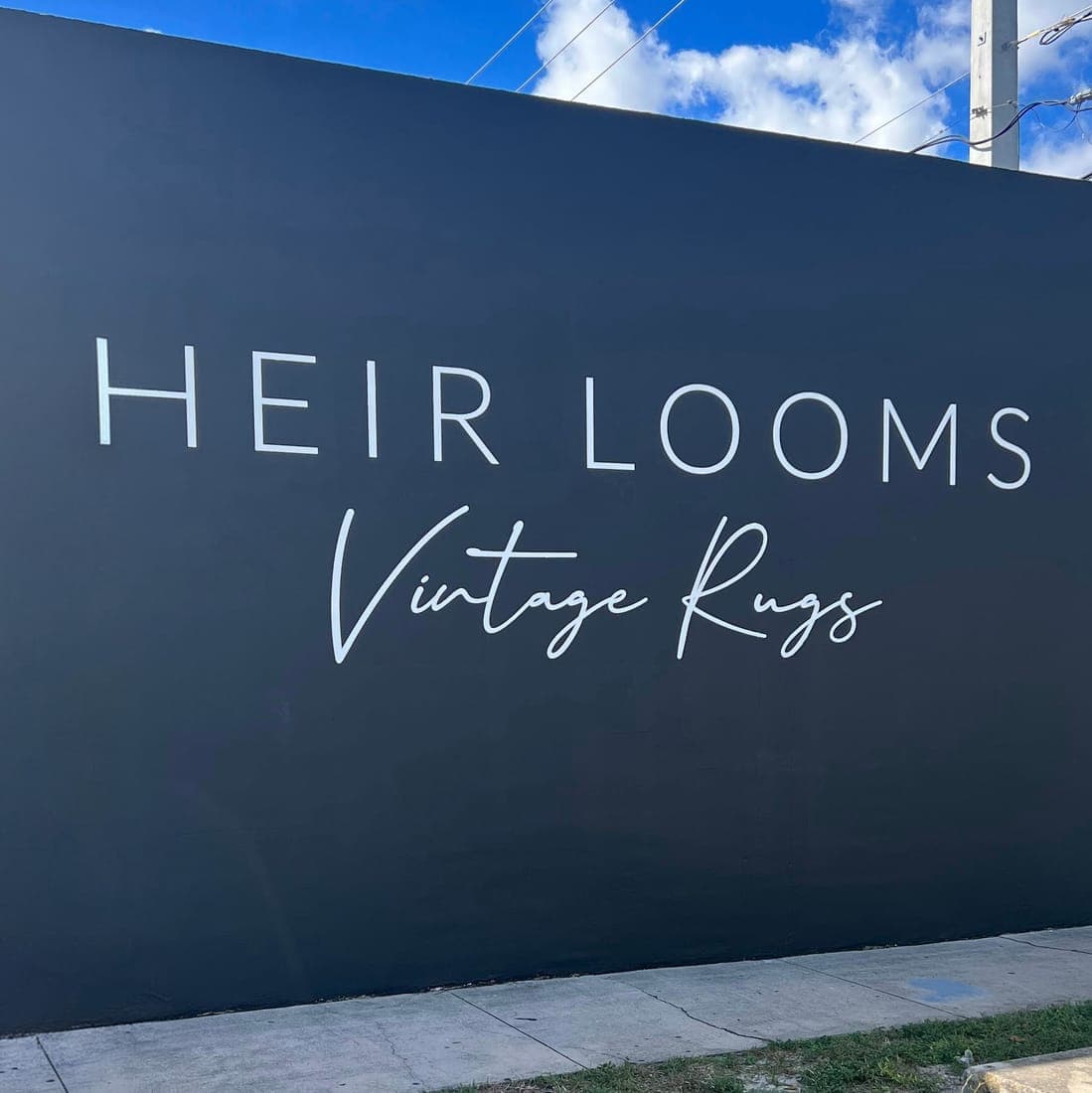 White dimensional lettering on a navy building wall